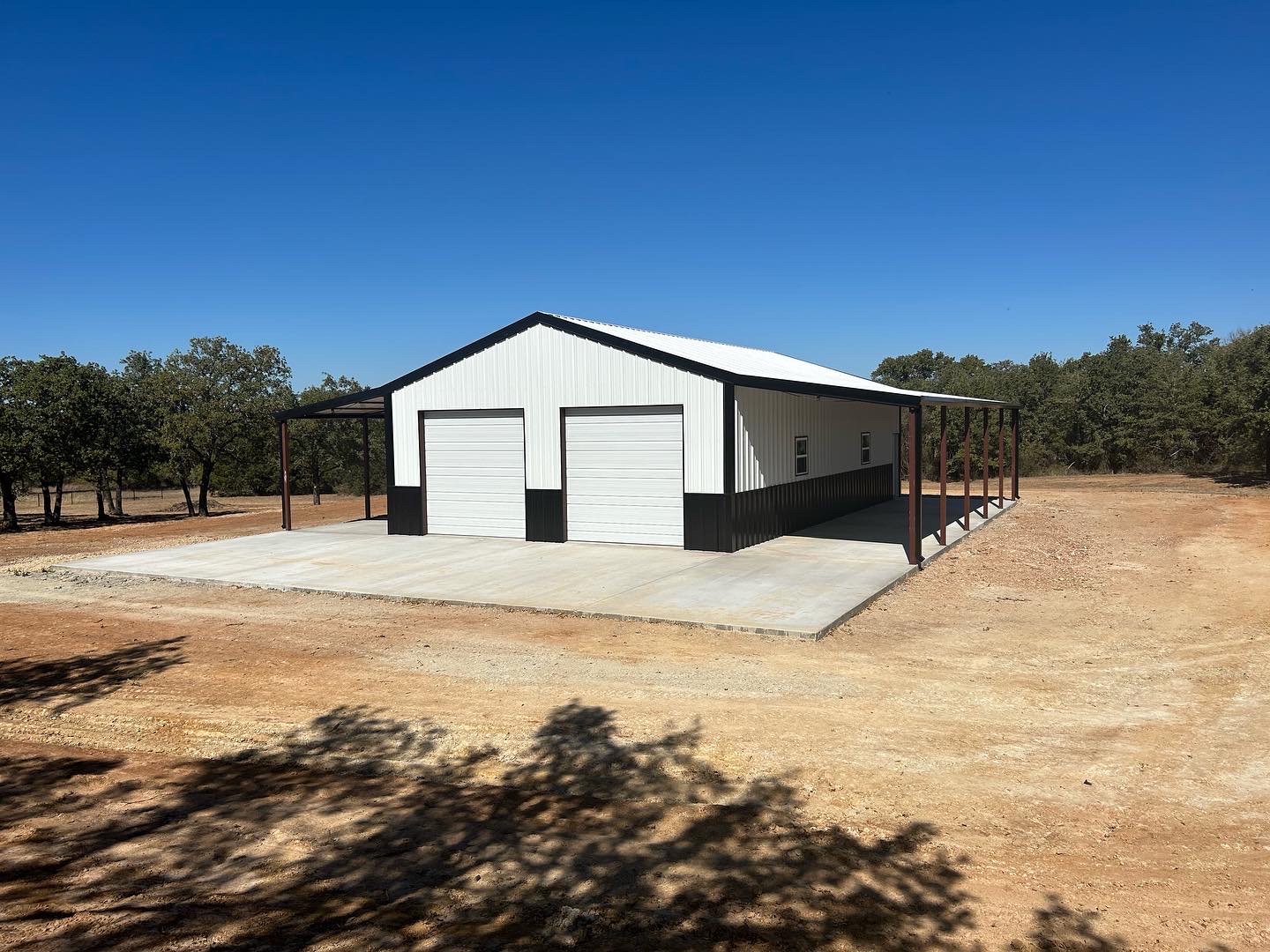 A white and black garage in the middle of nowhere.