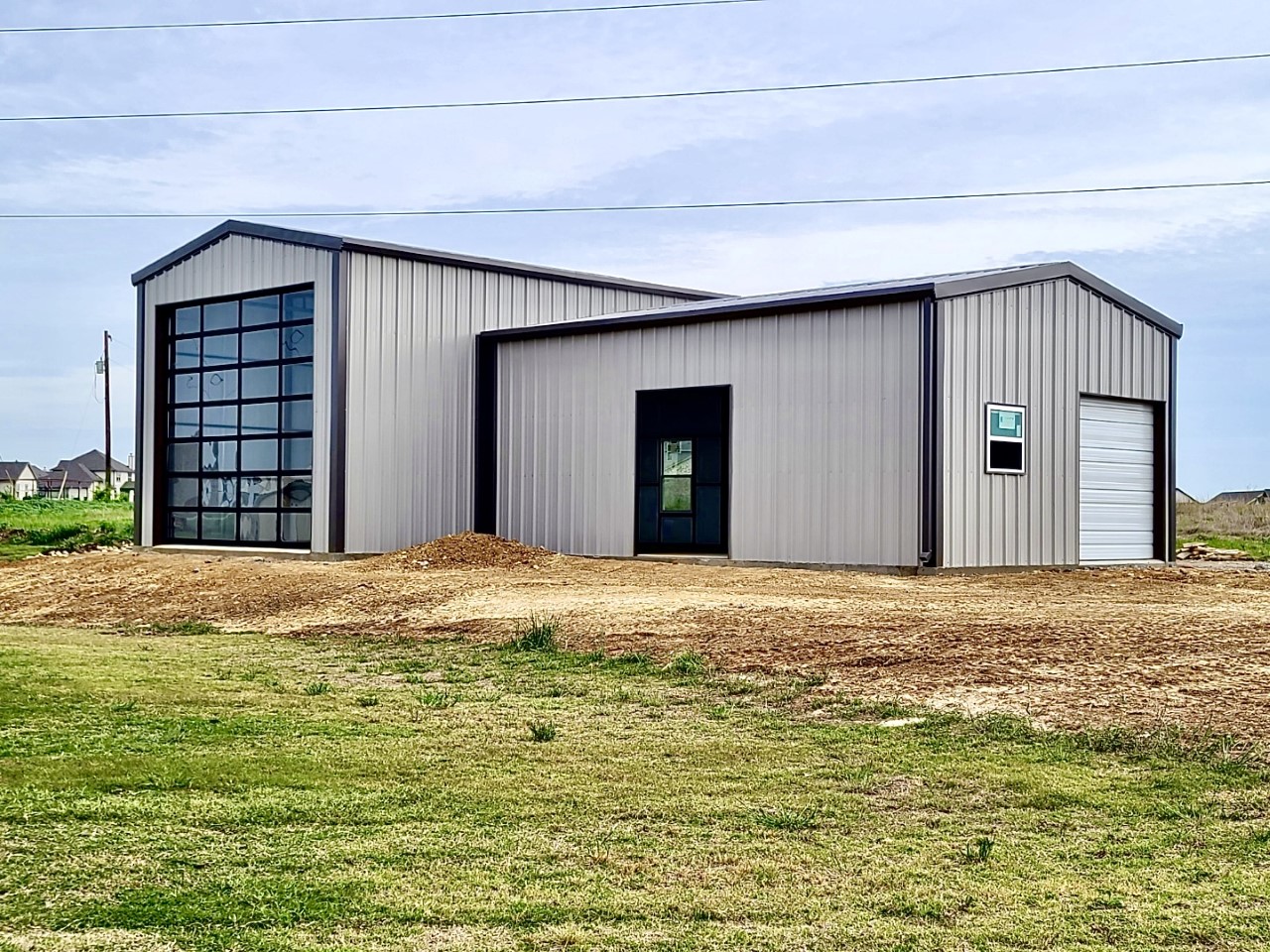 A large metal building with a garage door.