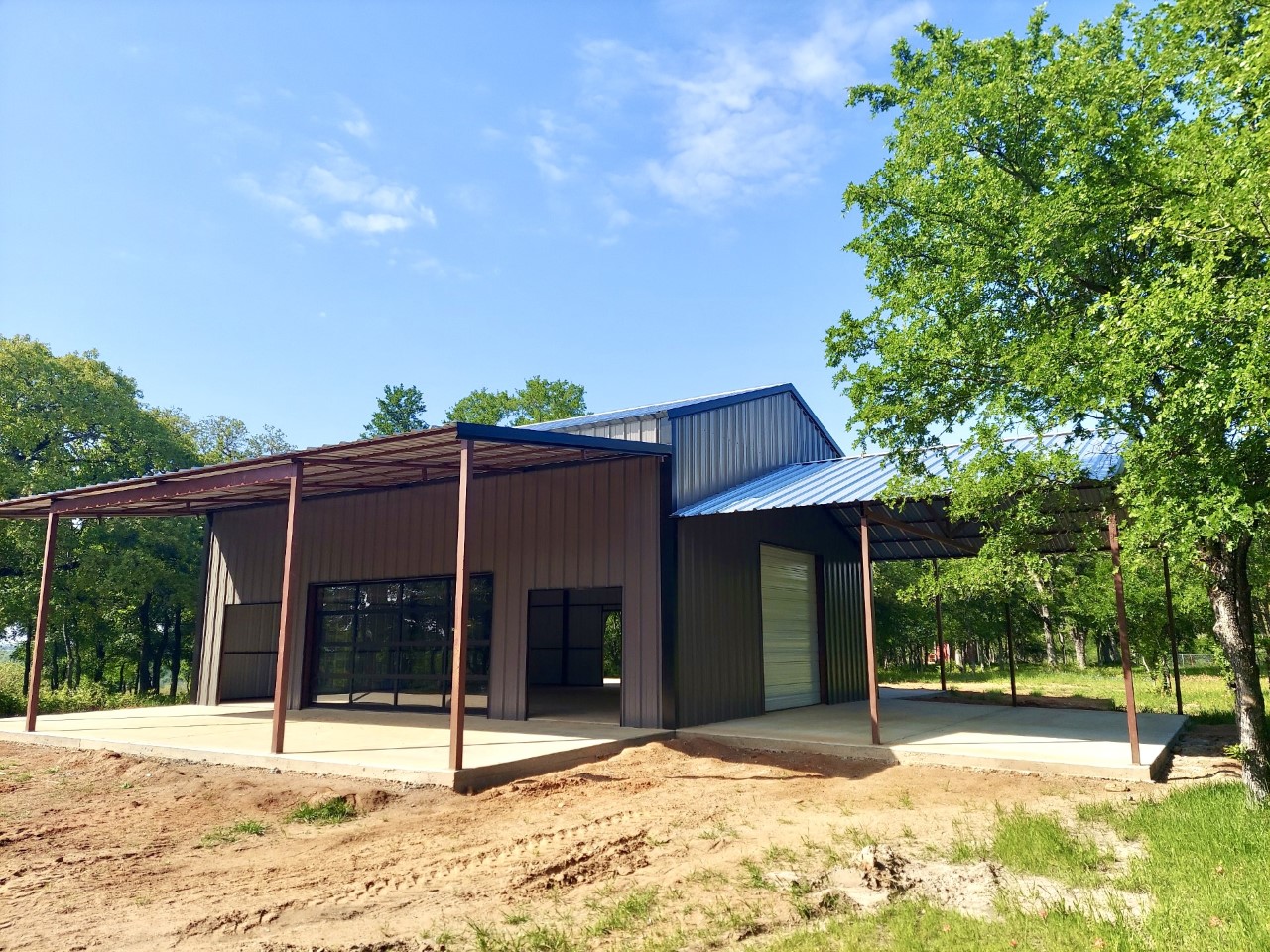 A building that is under construction with trees in the background.